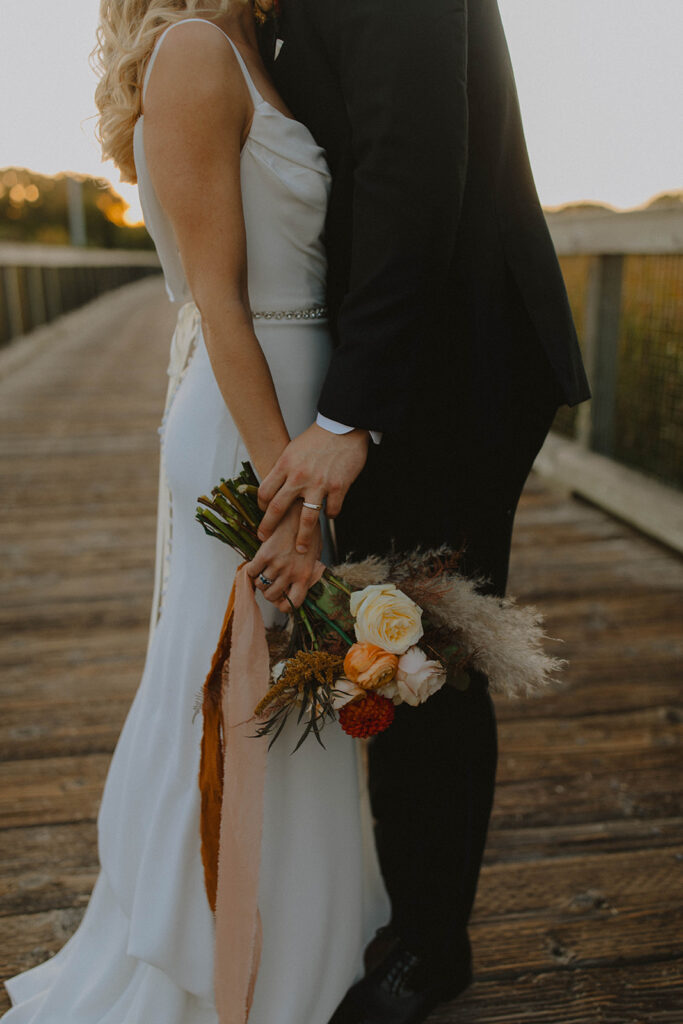 bride and groom at sunset looking at each other and smiling for the wedding photography narrative