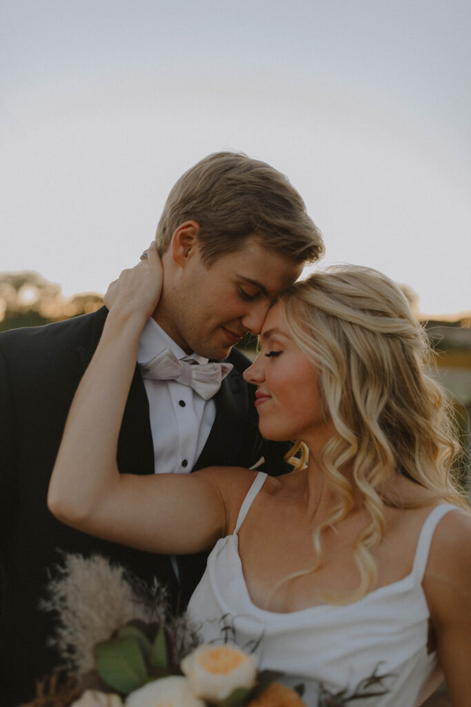 bride and groom at sunset looking at each other and smiling for the wedding photography narrative