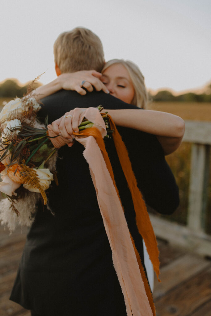 bride and groom at sunset looking at each other and smiling for the wedding photography narrative