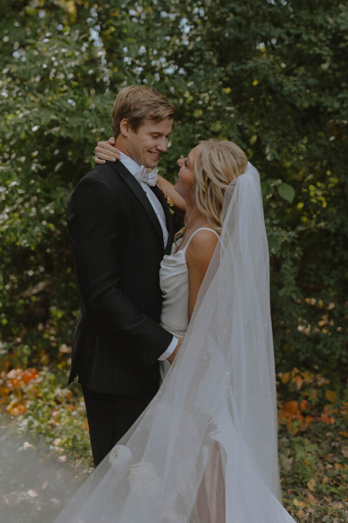 bride and groom shot of them looking at each other 